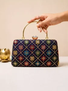 Blue Geometric: Clutiva sapphire blue statement clutch with traditional ethnic embroidery and top handle.