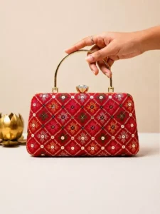 Red Geometric: Clutiva crimson red wedding clutch bag with colorful geometric embroidery and crystal clasp.