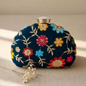 Navy Blue Floral Image: Clutiva navy blue premium handbag with multi-colored vibrant floral embroidery.