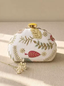 White/Gold Floral Image: Clutiva elegant white statement clutch with gold and pastel floral embroidery.