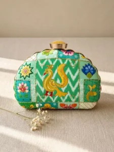 Peacock/Green Ikat Image: Clutiva green ikat embroidered luxury clutch with peacock motif and D-shape frame.