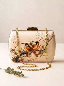 Elegant cream satin clutch bag featuring vintage orange birds and blossom branch artwork