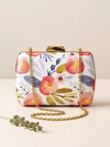 Statement luxury evening bag featuring an abstract amber and peach rose print