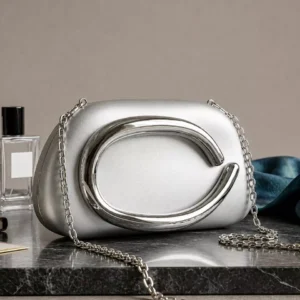 Clutiva Aura luxury silver acrylic clutch bag with mirror polished chrome abstract handle and sling chain