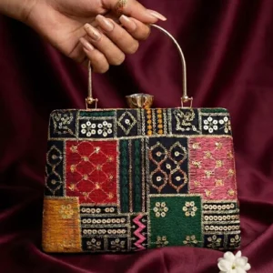 Multicolor patchwork embroidered designer clutch held by hand with gold chain handle – Clutiva