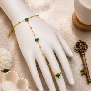 Gold bow hand harness bracelet with adjustable ring by Clutiva displayed on a mannequin hand in luxury studio styling.