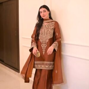 Woman wearing premium rust embroidered Chinon Silk kurta palazzo set with matching embroidered dupatta by Clutiva